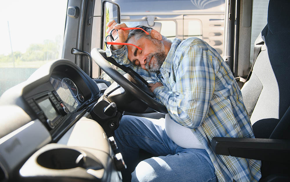 An exhausted truck driver taking a rest